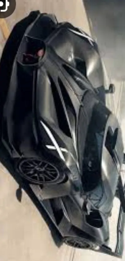 Sleek black sports car on pavement with dynamic design.