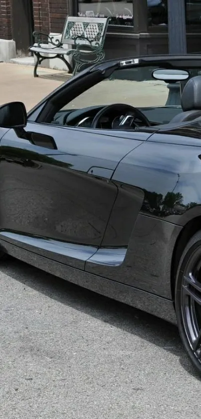 Sleek black sports car parked downtown, perfect for mobile wallpaper.