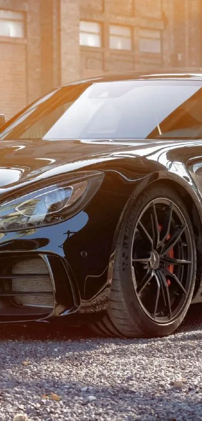 Sleek black sports car with glossy finish parked outdoors.