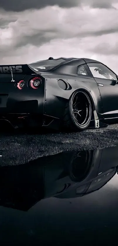 Sleek black sports car on a reflective surface with a moody sky backdrop.