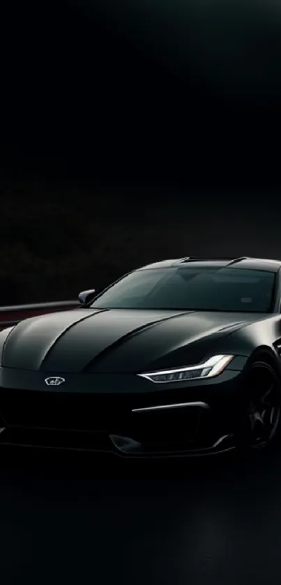 Sleek black sports car on a dark highway at night.