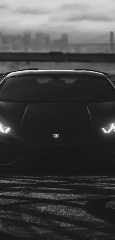 Black Lamborghini sports car with moody sky.