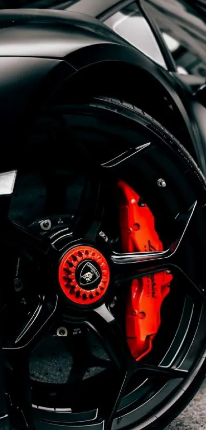 Close-up of a sleek black sports car wheel with vivid red accents.