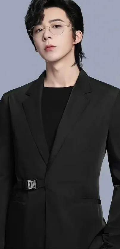 Person in sleek black suit on light gray background.