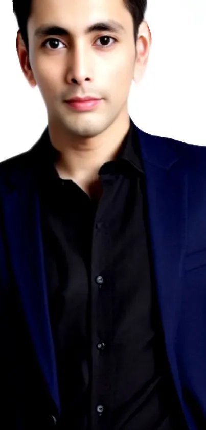 A man in a sleek black suit on a light background, looking professional and stylish.