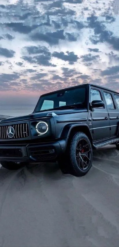 Black SUV on desert sand at dusk with dramatic sky backdrop.