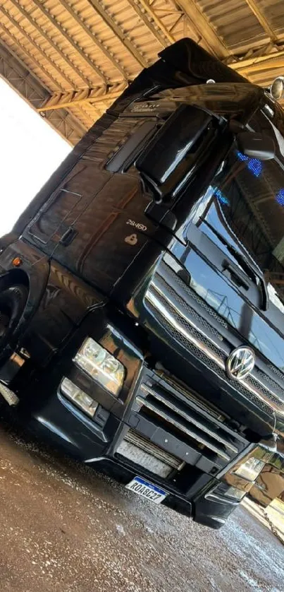 Sleek black Volkswagen truck under a roof.