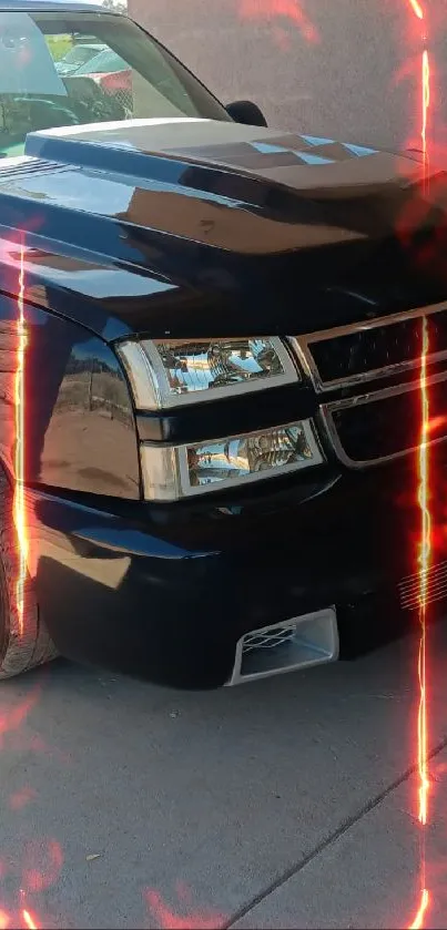 Sleek black truck parked in a shaded area, highlighting its glossy design.