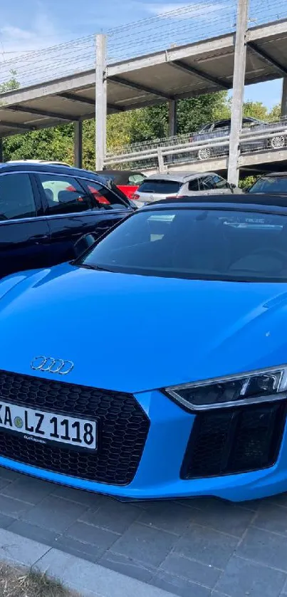 Blue sports car parked outdoors with a sleek design.