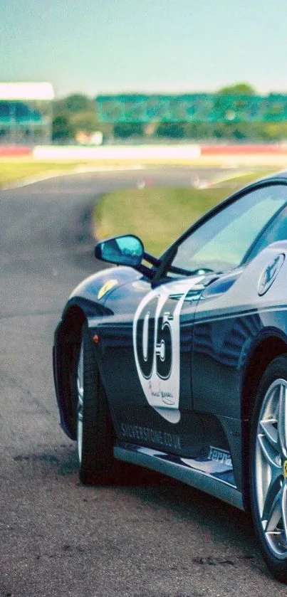 Sleek blue sports car racing on track.