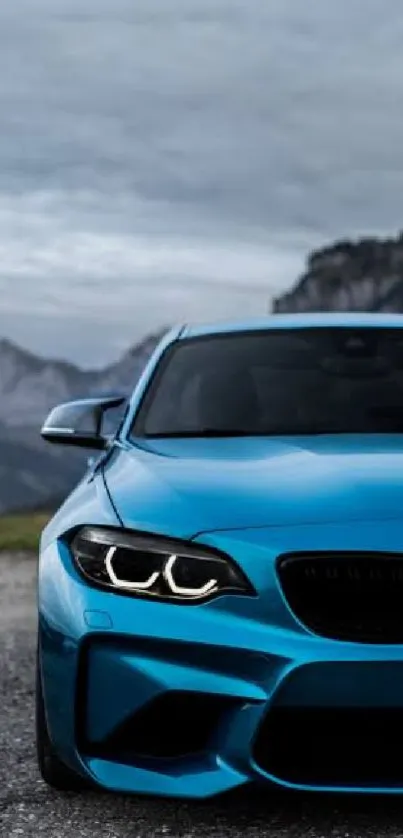 Sleek blue sports car in a mountainous landscape wallpaper.