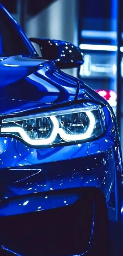 Sleek blue car with luminous headlights.