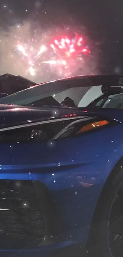 Blue sports car with fireworks in the night sky.