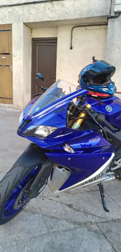 Sleek blue sport motorcycle parked in urban setting.