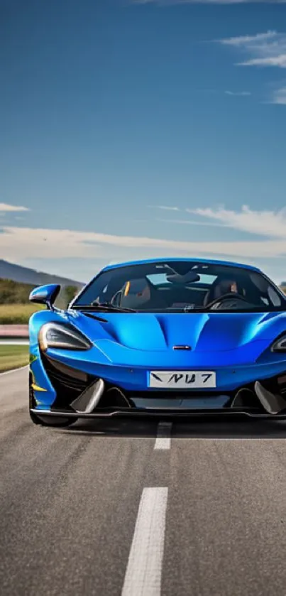 Blue sports car on open road under a clear sky.