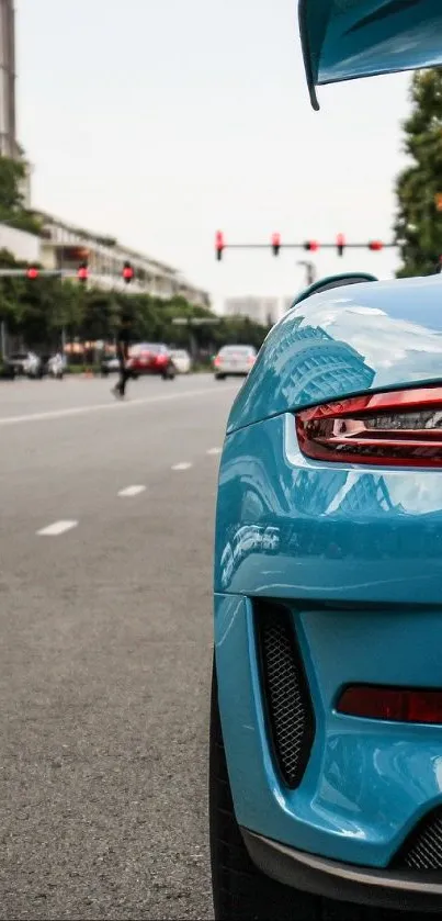 Turquoise sports car on city road.