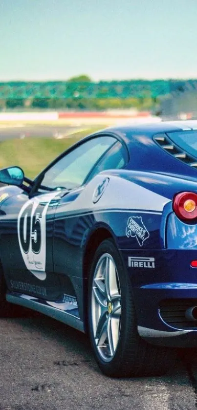 Blue sports car on race track wallpaper.