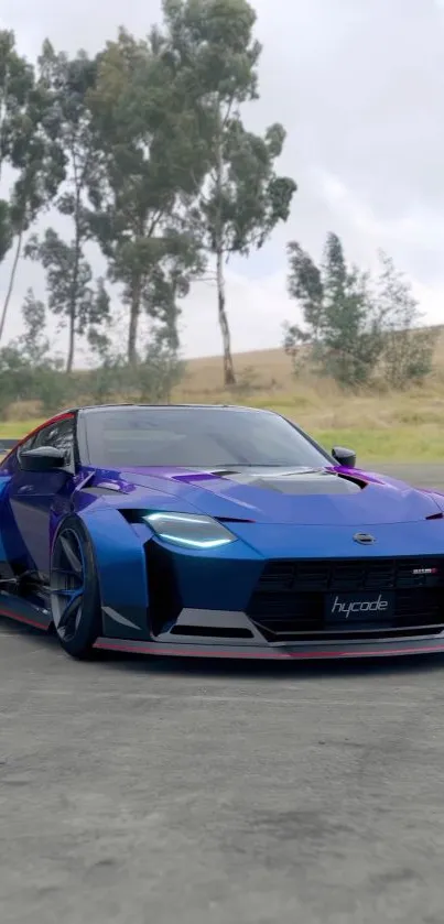 Sleek blue sports car parked on asphalt with trees in the background.