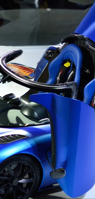 Sleek blue sports car with open doors.
