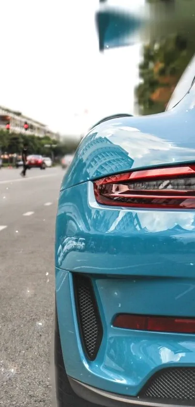 Sleek blue sports car on urban street wallpaper.