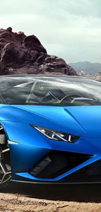 Blue sports car driving through rocky desert landscape.