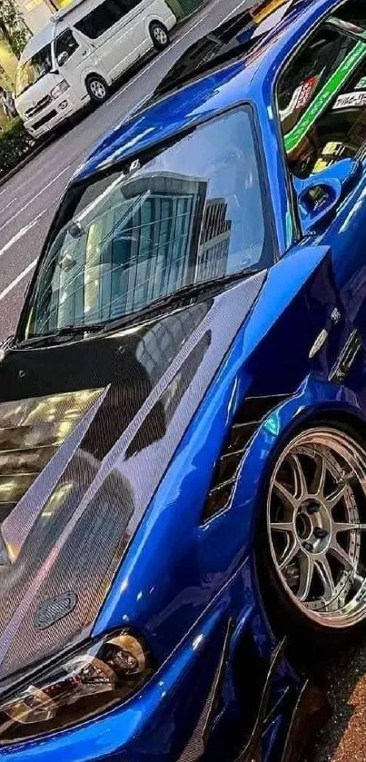 Sleek blue sports car parked on a street.