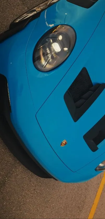 Sleek blue sports car front view close-up.