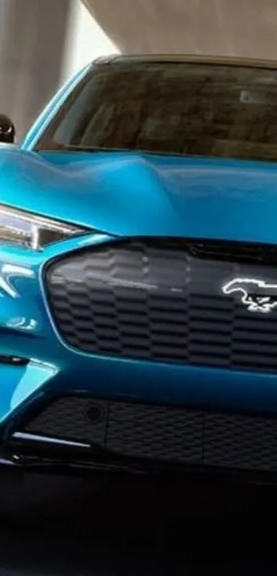 Sleek blue sports car under a bridge, front view.