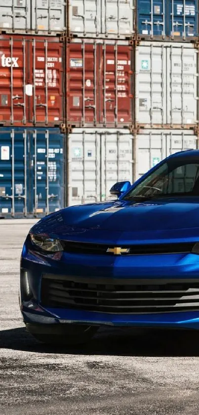 Sleek blue sports car parked in front of colorful shipping containers.