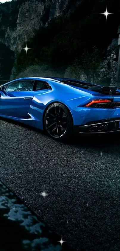 Blue sports car on road with mountain backdrop.