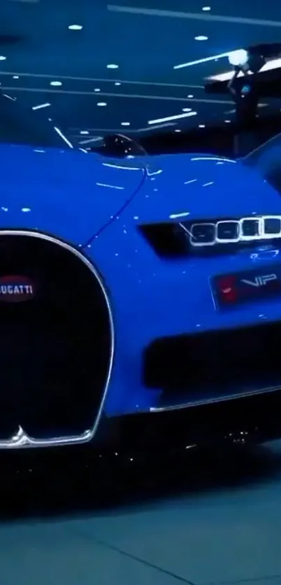 Blue luxury sports car in dimly lit showroom.