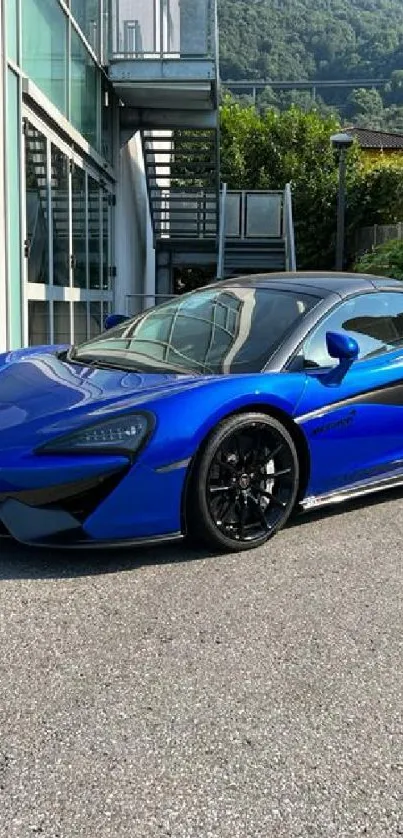 Blue sports car parked outside in the sun.