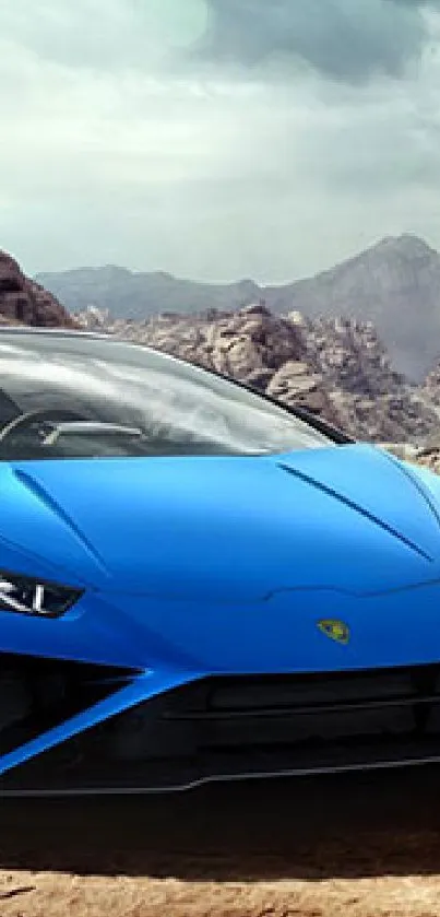 Blue sports car on desert road with mountain backdrop.