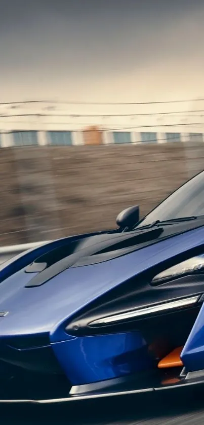 Sleek blue supercar driving on racetrack, showcasing speed and elegance.