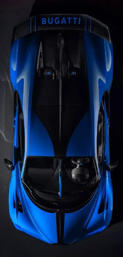 Top view of sleek blue Bugatti car on a dark background.