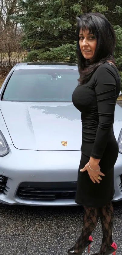 Elegant woman in black dress beside a silver car