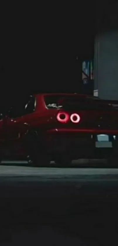 Red sports car parked at night with glowing taillights.