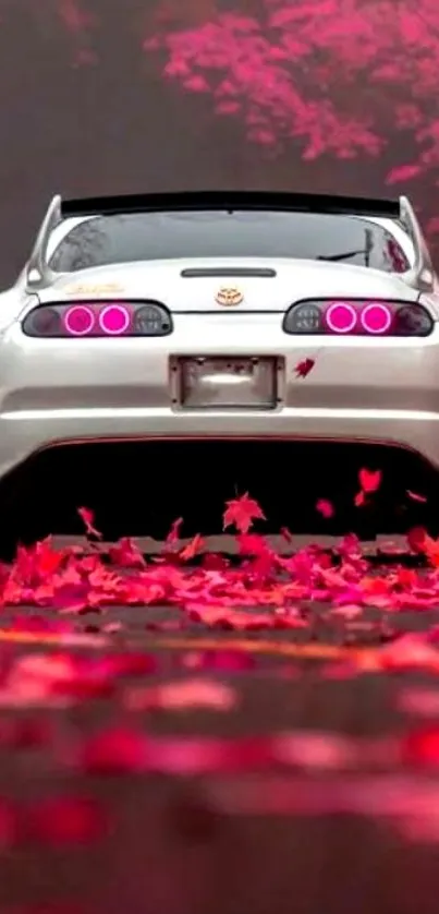 Sleek car surrounded by vibrant autumn leaves, creating a stunning mobile wallpaper.