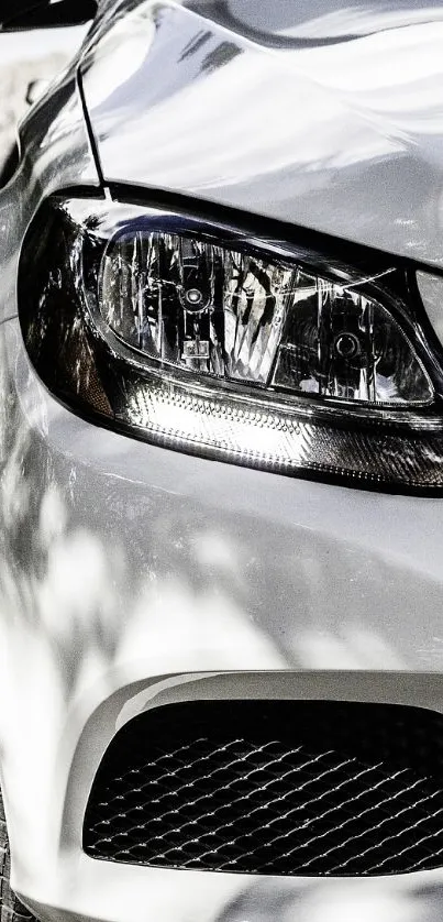 Sleek front view of a white luxury car under natural light.