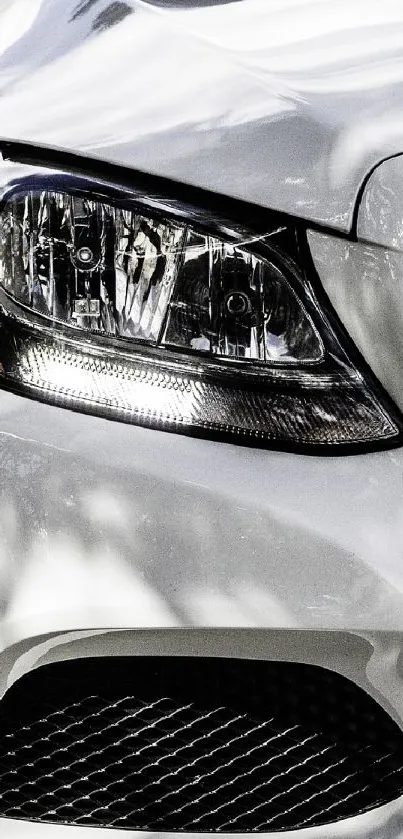 Close-up of a modern car headlight with sleek design and lighting elements.