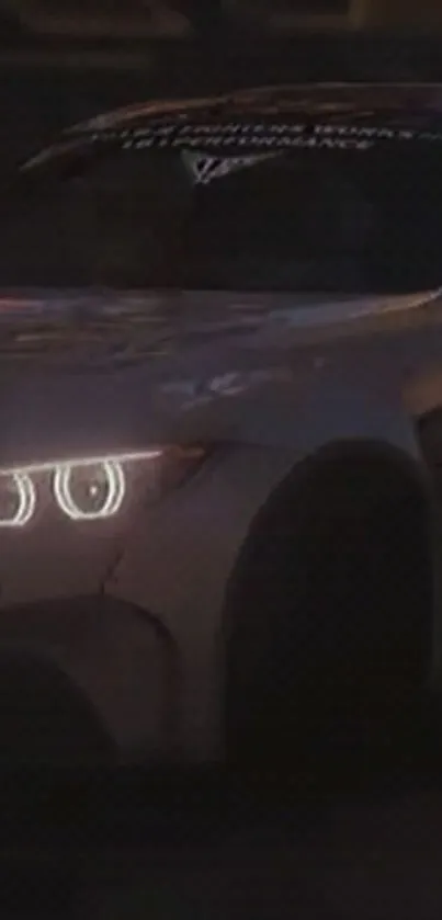 Car with bright headlights driving at night.