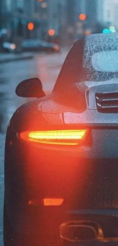 Sleek car with glowing taillights in a rainy urban setting.