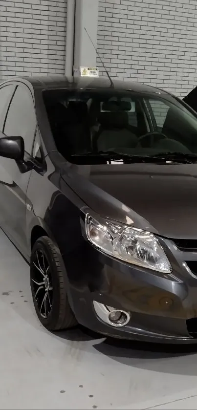 Sleek gray car parked in urban garage setting.