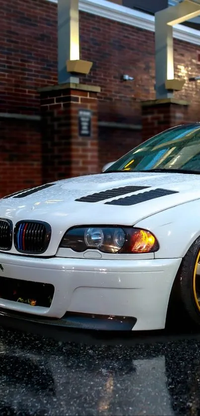 Styled car with golden rims in urban night setting.