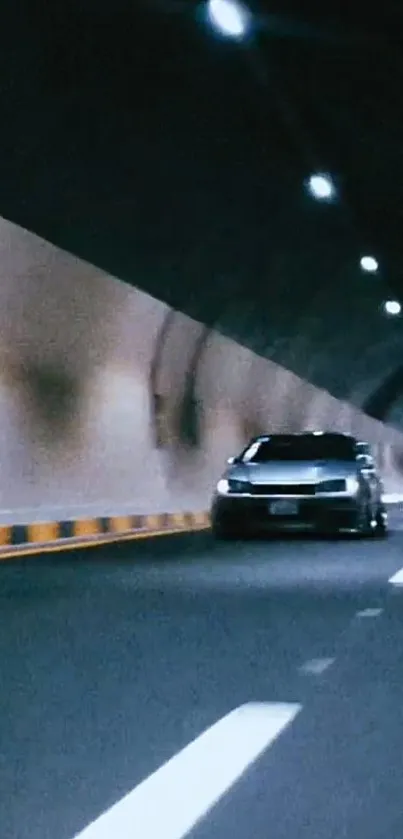 Car speeding through an urban tunnel at night.