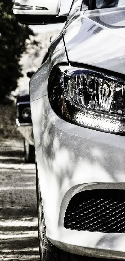 Close-up of a sleek, white luxury car on a road, captured in a modern style.