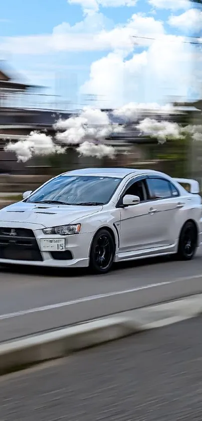 White sports car speeding on city street.