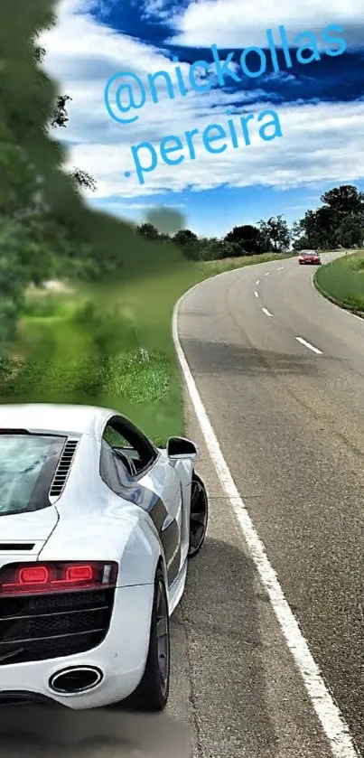 Luxurious sports car on a scenic winding road under a clear sky.