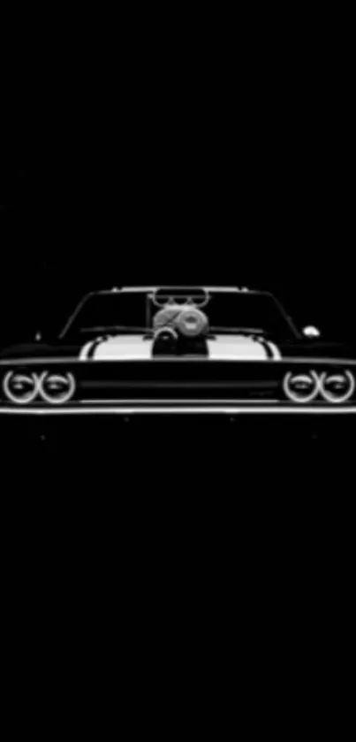 Sleek silhouette of a vintage car on a dark background.