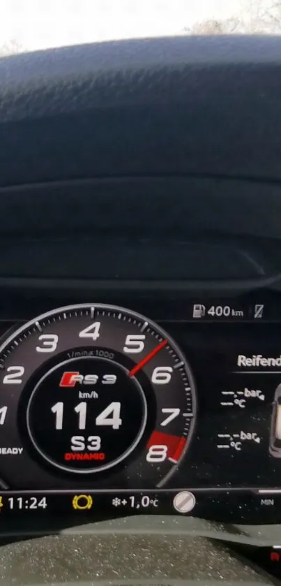 Car speedometer displaying 114 km/h with sleek dashboard design.